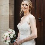 Bride holding bouquet in white dress