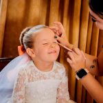 Young girl having makeup applied